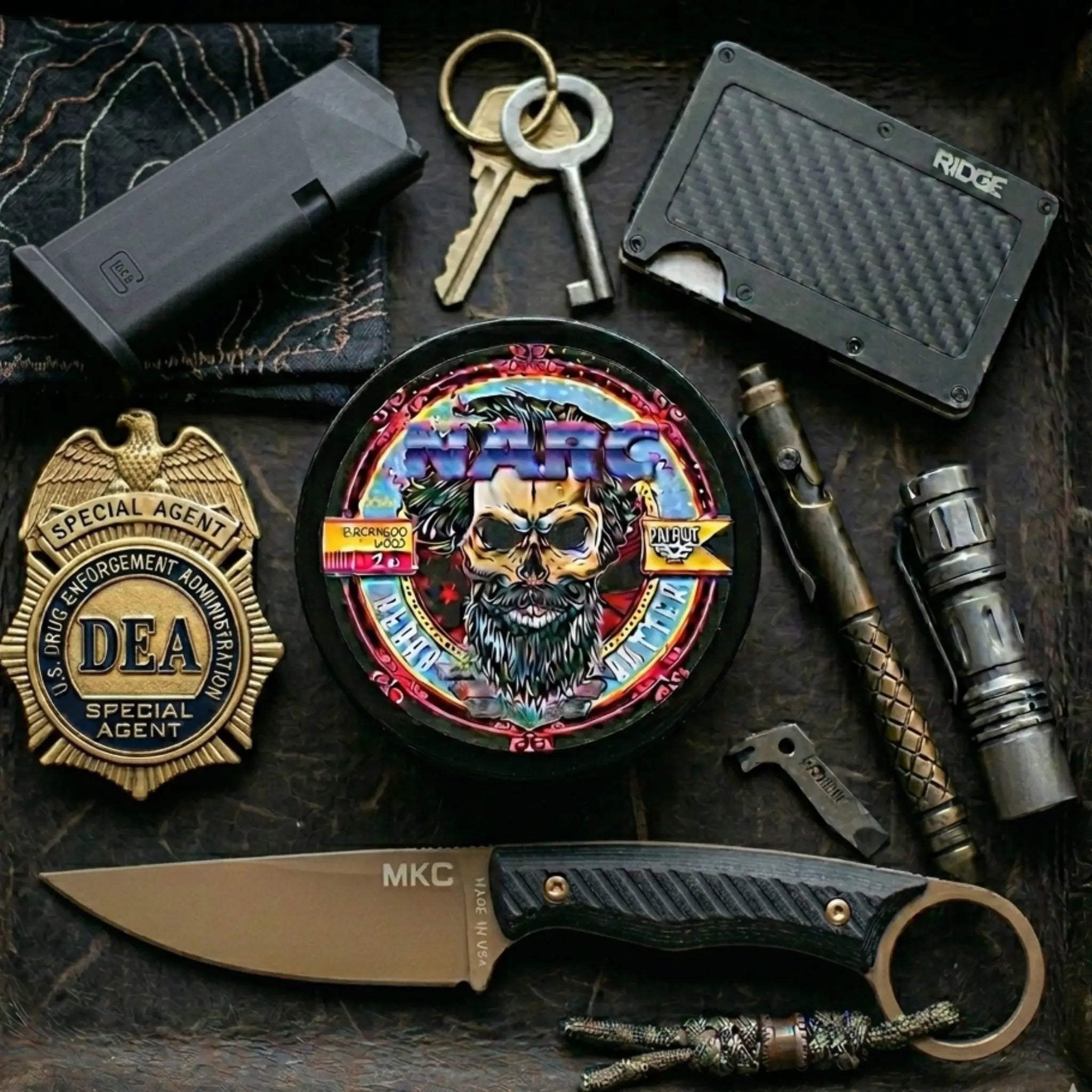 Tactical EDC flat lay featuring NARC beard butter alongside a DEA Special Agent badge, an MKC (Montana Knife Company) blade, a Glock magazine, a Ridge wallet, and a bolt-action pen.