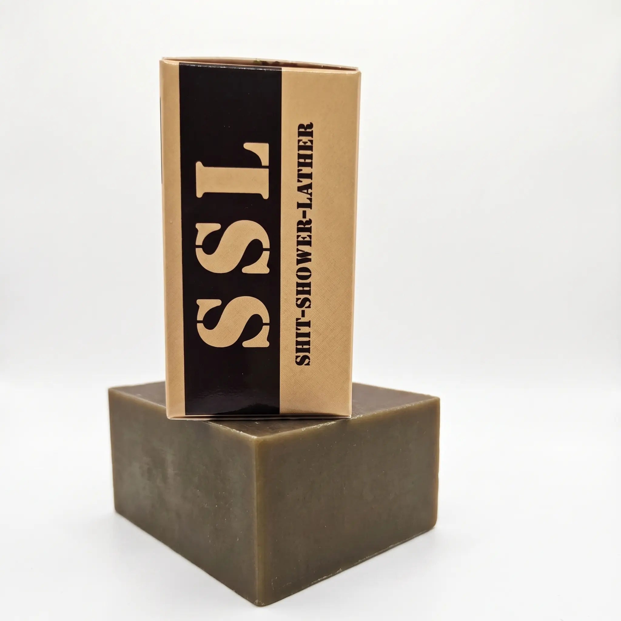 Side view of Flagship Soap Company "Cup of Joe" Mocha Coffee soap bar. The tan packaging prominently displays the mocha coffee scent and the circular "Shit-Shower-Lather" seal. This exfoliating coffee soap is a premium veteran-owned grooming product for men.