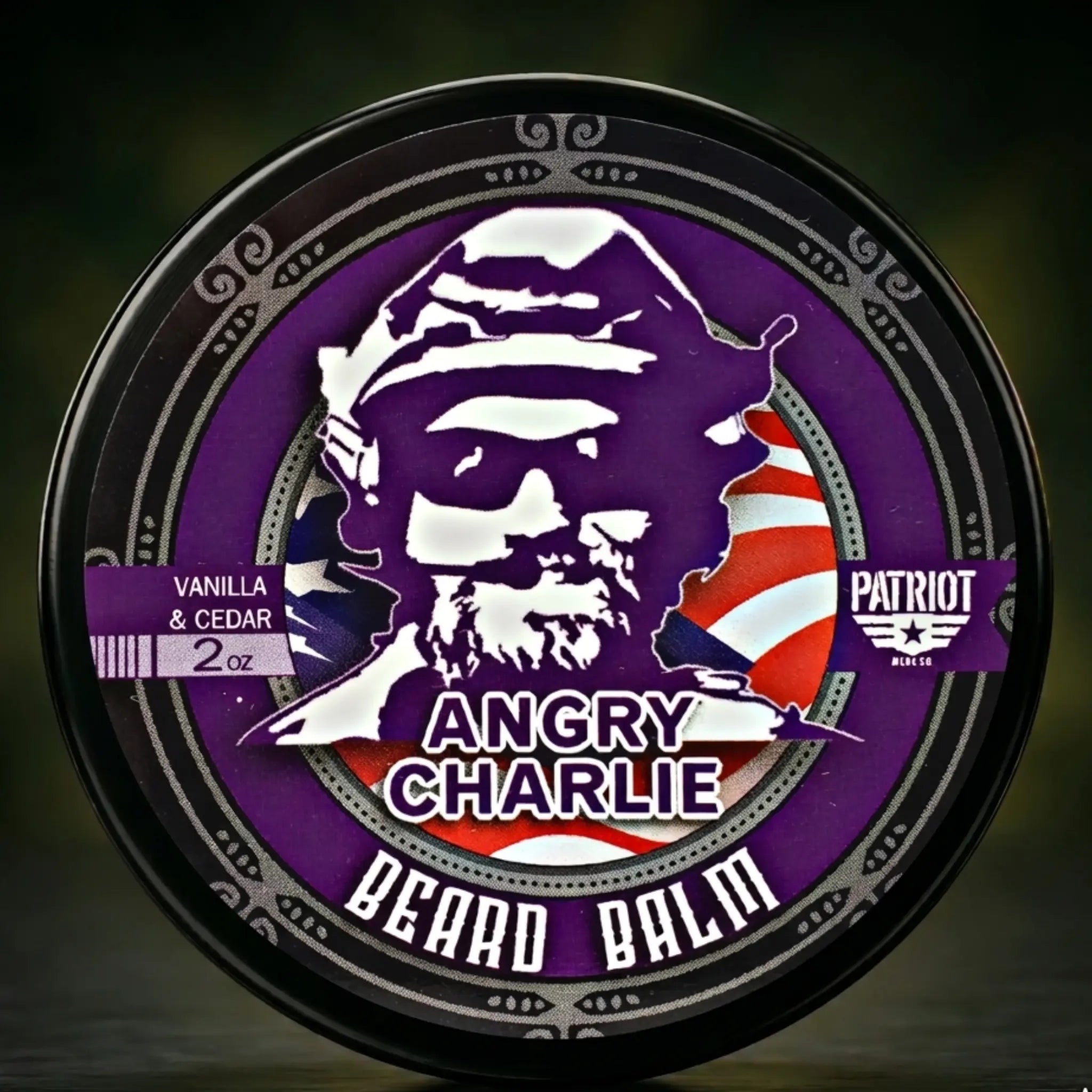 Flagship Soap Company Angry Charlie Beard Balm in a 2oz plastic container with a screw-on lid. This formula softens the beard, prevents itching, and promotes healthy skin and hair. Scent Profile: A robust blend of Monticello Vanilla and Cedar. Lifestyle: 100% of profits are donated to the Aaron Butler Memorial Foundation.