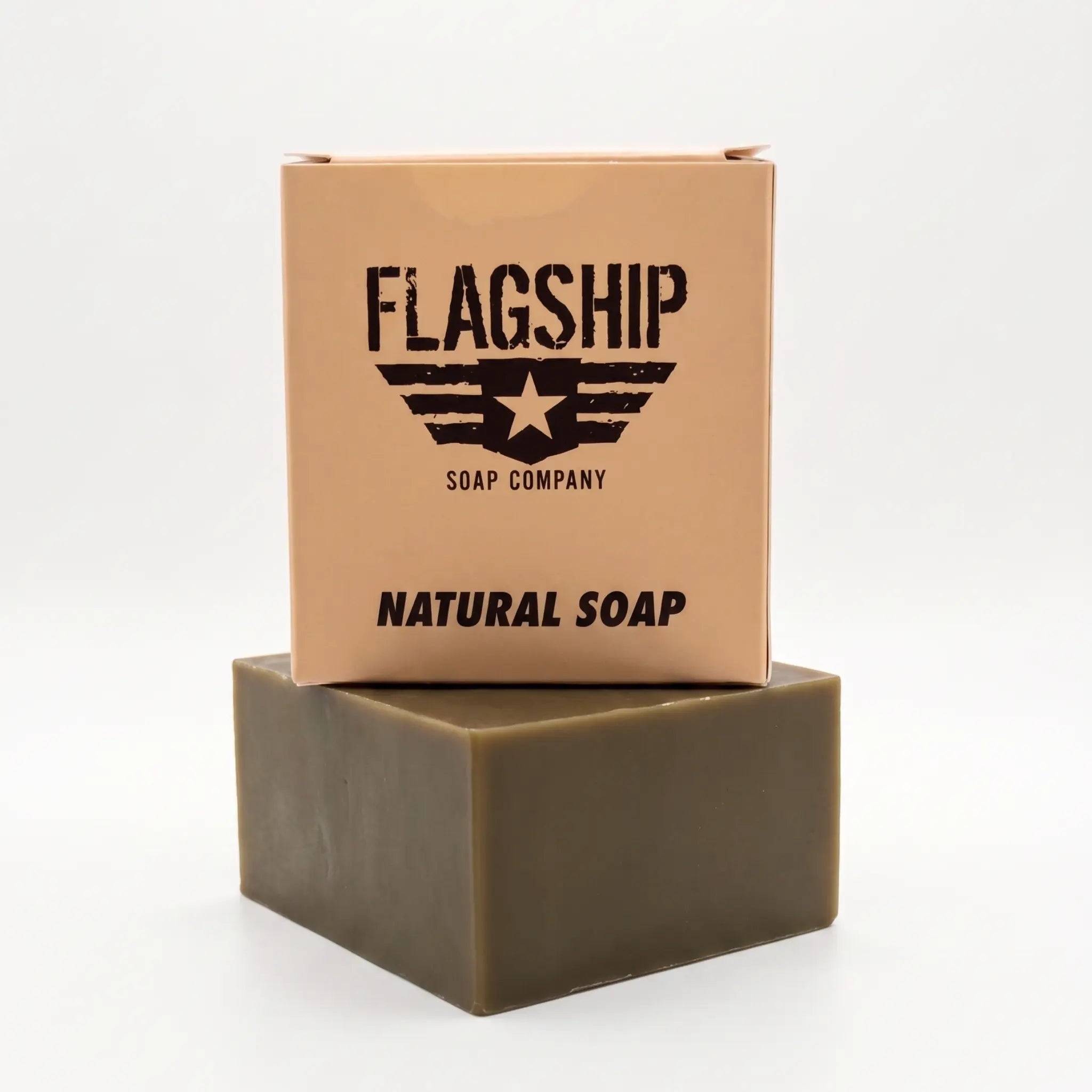 Front view of Flagship Soap Company Natural Soap bar in a tan box with the black stencil wing and star logo. This veteran-owned large 5.56 oz soap bar features a rugged, military-inspired aesthetic and premium natural ingredients.