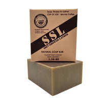 Flagship Soap Company "Cup of Joe" natural mocha coffee soap bar (5.56 oz) in tan MRE-inspired packaging. Features "SSL: Shit-Shower-Lather" branding, Warfighter Tested endorsement, and medium exfoliation with real coffee grounds.