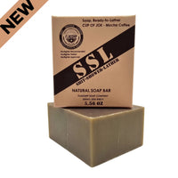 Flagship Soap Company "Cup of Joe" natural mocha coffee soap bar (5.56 oz) in tan MRE-inspired packaging. Features "SSL: Shit-Shower-Lather" branding, Warfighter Tested endorsement, and medium exfoliation with real coffee grounds. NEW