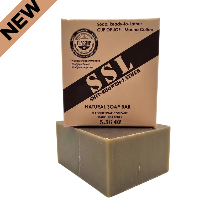 Flagship Soap Company "Cup of Joe" natural mocha coffee soap bar (5.56 oz) in tan MRE-inspired packaging. Features "SSL: Shit-Shower-Lather" branding, Warfighter Tested endorsement, and medium exfoliation with real coffee grounds. NEW