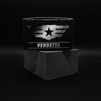 Top view of the Vendetta soap box by Flagship Soap Company resting on a black activated charcoal soap bar. The packaging features a silver tactical wing and star logo against a sleek black box.