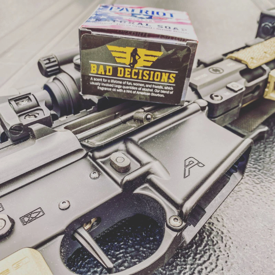 Bad Decisions Whiskey Natural Soap with bar of soap and soap box sitting on a rifle.  Tactical Soap by Patriot and Company
