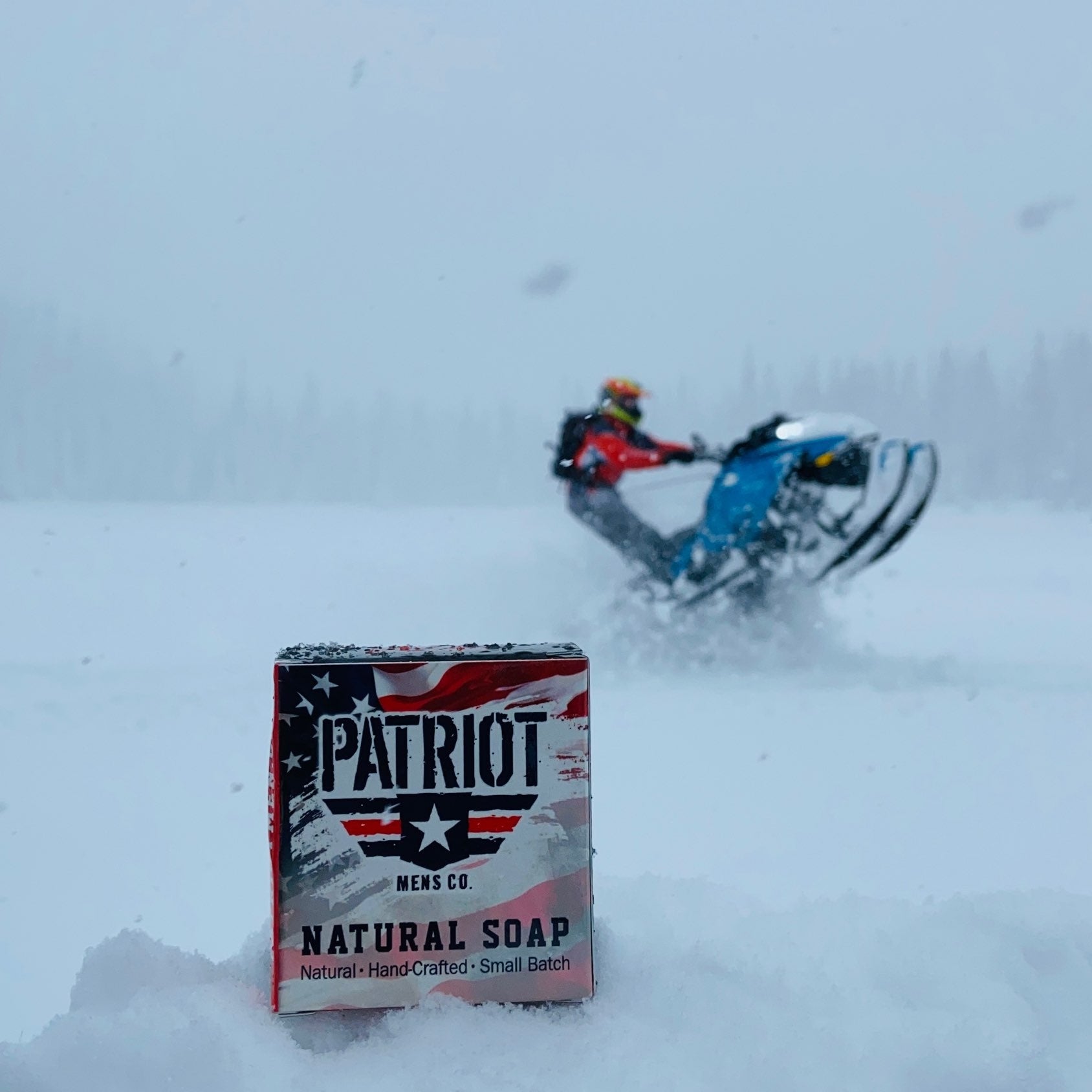Leather and Oakmoss Natural Men's Soap with snowmobiler in background by Patriot and Company.