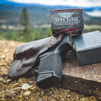 Down Range natural men's soap, smell's like gunpowder, by Patriot and Company activated charcoal soap bar of soap with glock with Idaho mountains in background.
